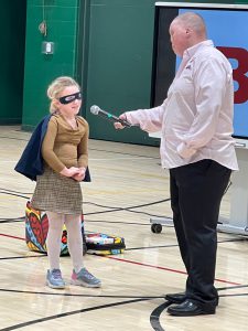 Girl dressed as superhero talks to man.