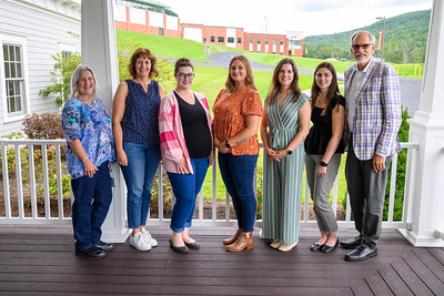 School Based Health Care staff stand together on porch.