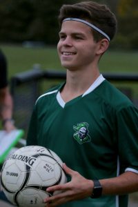 Austin Johns hold soccer ball.