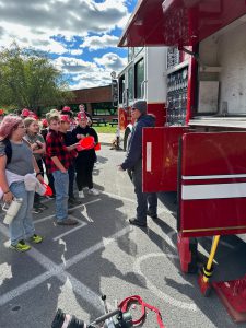 Students near fire truck.