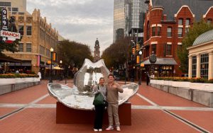 Two teens stand in front of giant cowboy hat in Dallas, Texas