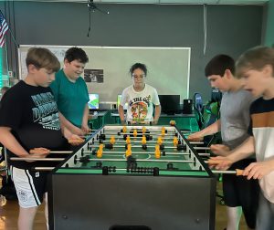 Students playing foosball.