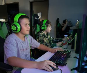 Students wearing headphones in Game Room.