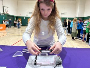 Girl manipulates glass at laser display