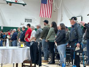 Veterans standing in a line during ceremony.