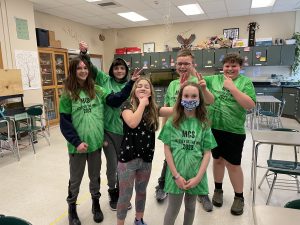 Odyssey of the Mind team in matching green t-shirts.