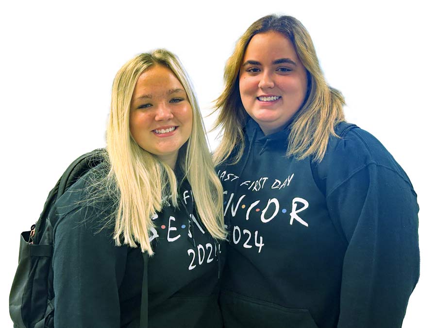 Two high school seniors standing together and smiling