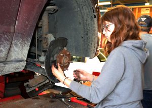 Student Katrina Graves works on a car.