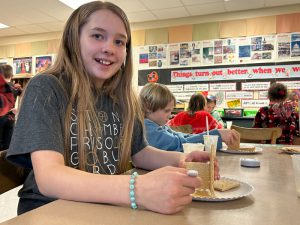 Student works on gingerbread house.