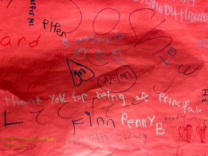 Banner with welcome back messages written by elementary students.