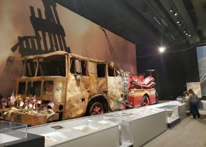 Display of burned-out fire truck at 911 exhibit.
