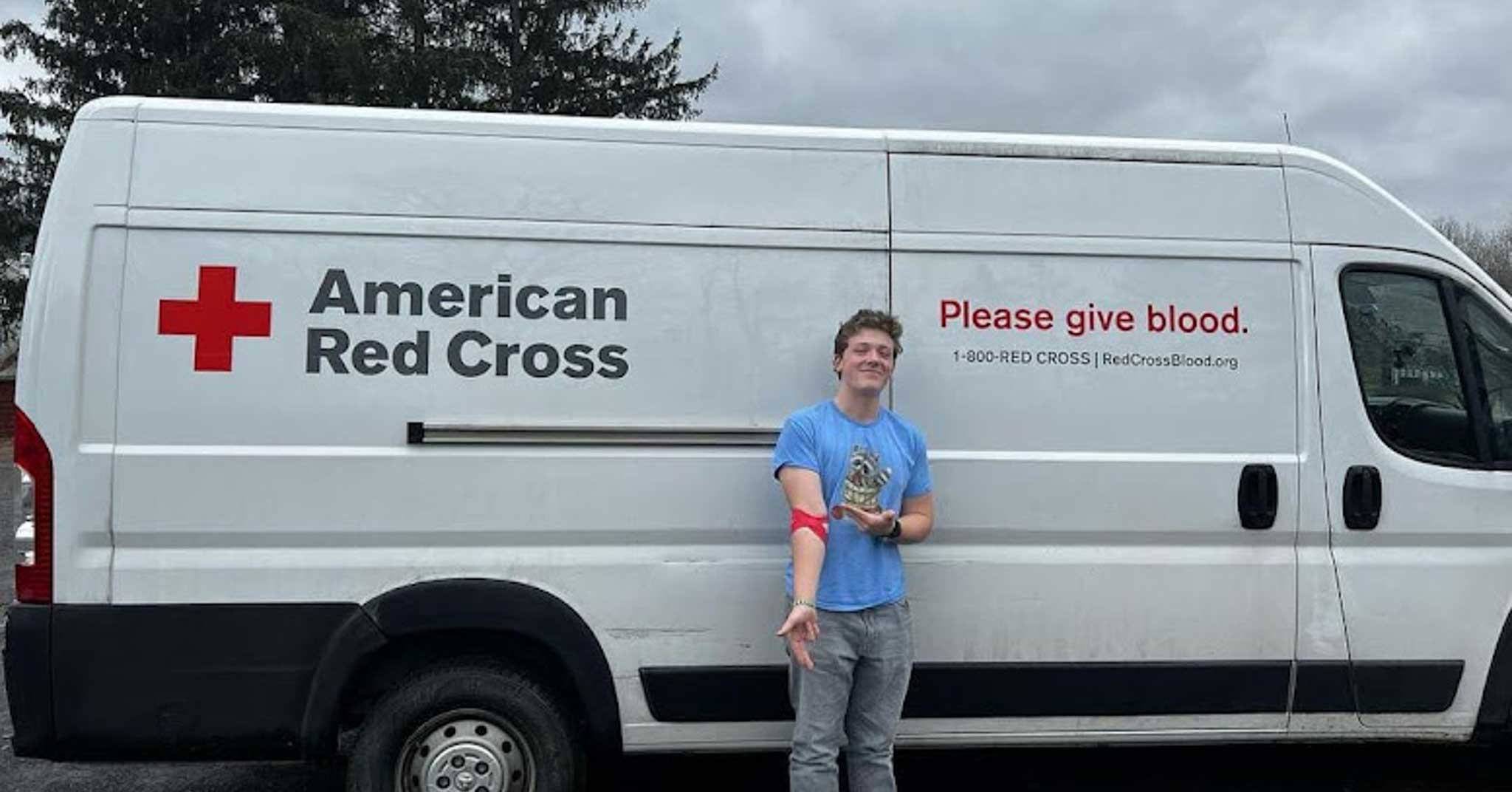 Teen holds out arm in front of American Red Cross ban