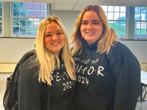 Two teens wearing senior 2024 hoodies.