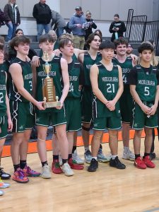 Boys basketball team with trophy.