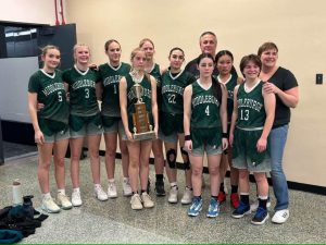 Girls basketball team with trophy.