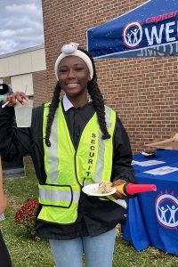 Student wearing a reflective yellow security vest.