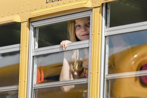Girl looks out of school bus window