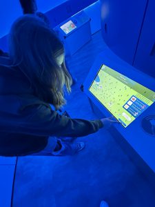 Student presses button on digital display.