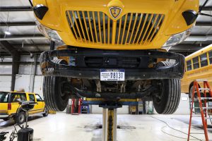 Middleburgh bus on lift in garage.