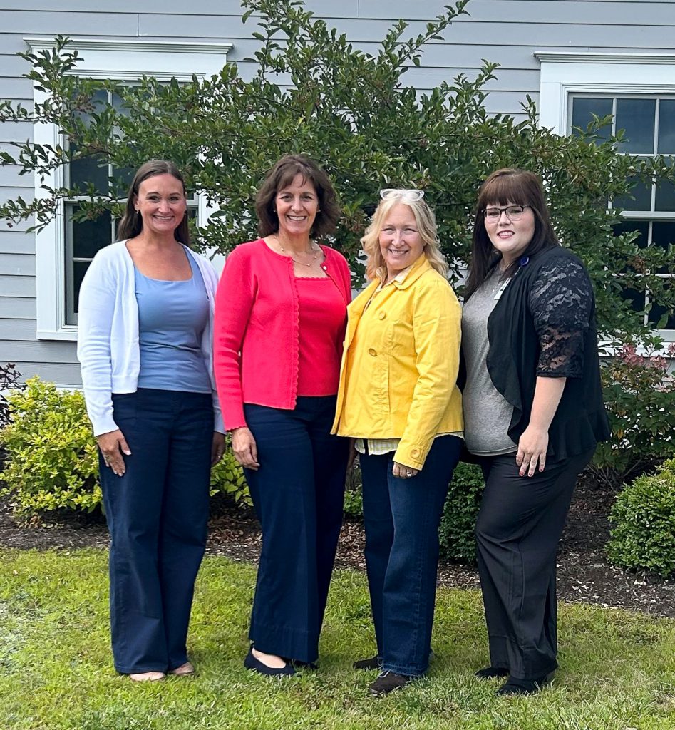 Four members of the Bassett School-Based Health Clinic stand together on an August day.
