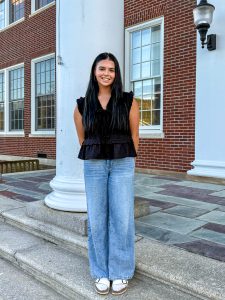 Brooke Devlin standing on steps of high school.