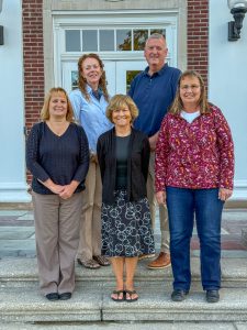 The five members of the Middleburgh Central School District Board of Education stand on the steps of the high school.