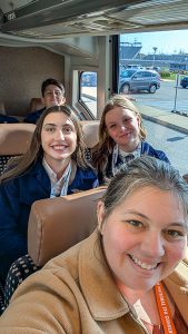 Three students and one teacher on bus.