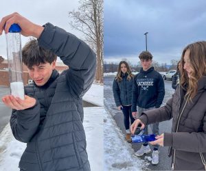 On left: Three students stand outside on a snowy pavement, with one student in the foreground holding a small blue tray and collecting a snow sample. Cars and winter trees are visible in the background under a cloudy sky.
On right: Three students stand outside on a snowy pavement, with one student in the foreground holding a small blue tray and collecting a snow sample. Cars and winter trees are visible in the background under a cloudy sky.