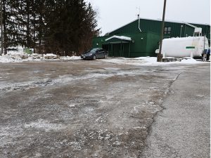 A parking lot displays deterioration.