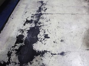 Closeup of a concrete floor displays deterioration.