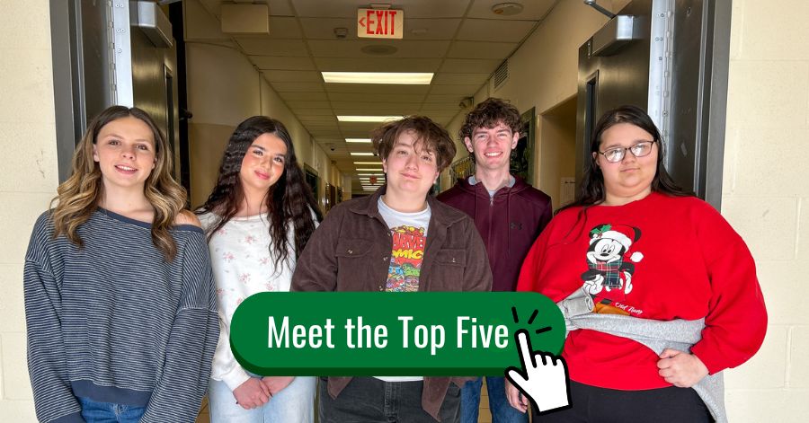 A group of five students standing together in a school hallway beneath a doorway with an exit sign overhead. Meet the Top Five. Hand click emoji