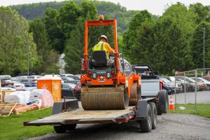 A steamroller on a flatbed trailer.