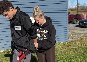 Teens practice an arrest during criminal justice class.