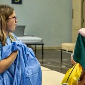 A student folds laundry during a service activity at the HOBY leadership seminar.