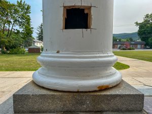 White column with inspection opening near base.