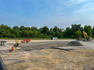 Drainage pipes staged near school bus garage.