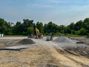 Drainage pipes staged near school bus garage.
