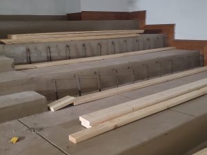 Construction materials in balcony seating area.