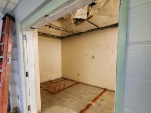 Partial demolition of high school cafeteria bathroom space.