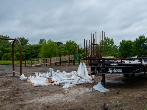 Playground under construction in a muddy field.