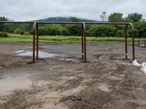 Playground under construction in a muddy field.