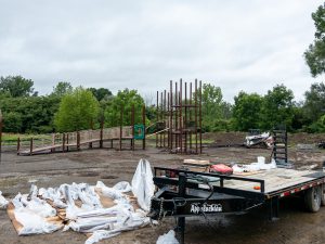 Playground under construction in a muddy field.