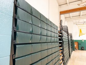 Folded bleachers in a gymnasium.