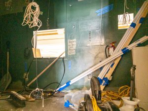 Backstage area with construction materials and utility work in progress.