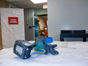 Work gloves and construction plans on a project table.