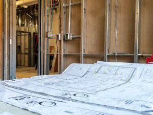 Blueprints on a table in an interior construction site.