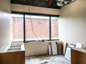Health clinic renovation area with cabinetry installation in progress.