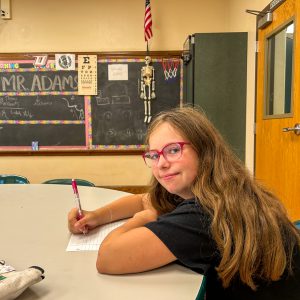 A student participates in a Constitution Day activity by writing responses during a classroom lesson focused on constitutional principles and civic learning.