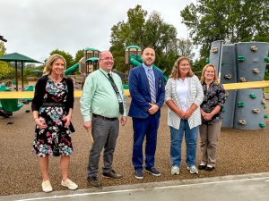 School Business Administrator Robyn Bhend, Superintendent Mark Place, Elementary School Principal Dr. Nicholas Comproski; BOE President Pamela Standhart, and BOE Vice President Becky Binder
 stand in front of the newly opened playground during a ribbon-cutting event.  