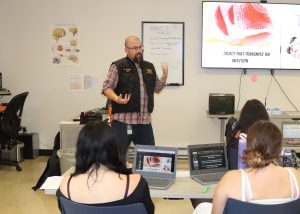 Instructor gives lecture to high school EMT students.